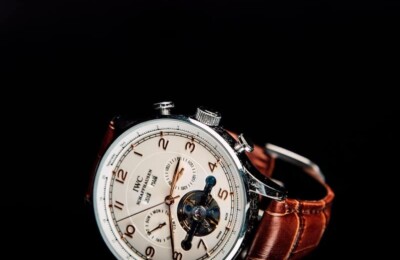 round silver-colored chronograph watch with brown leather strap