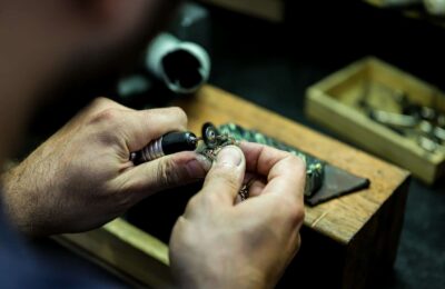 person wearing silver ring with black gemstone